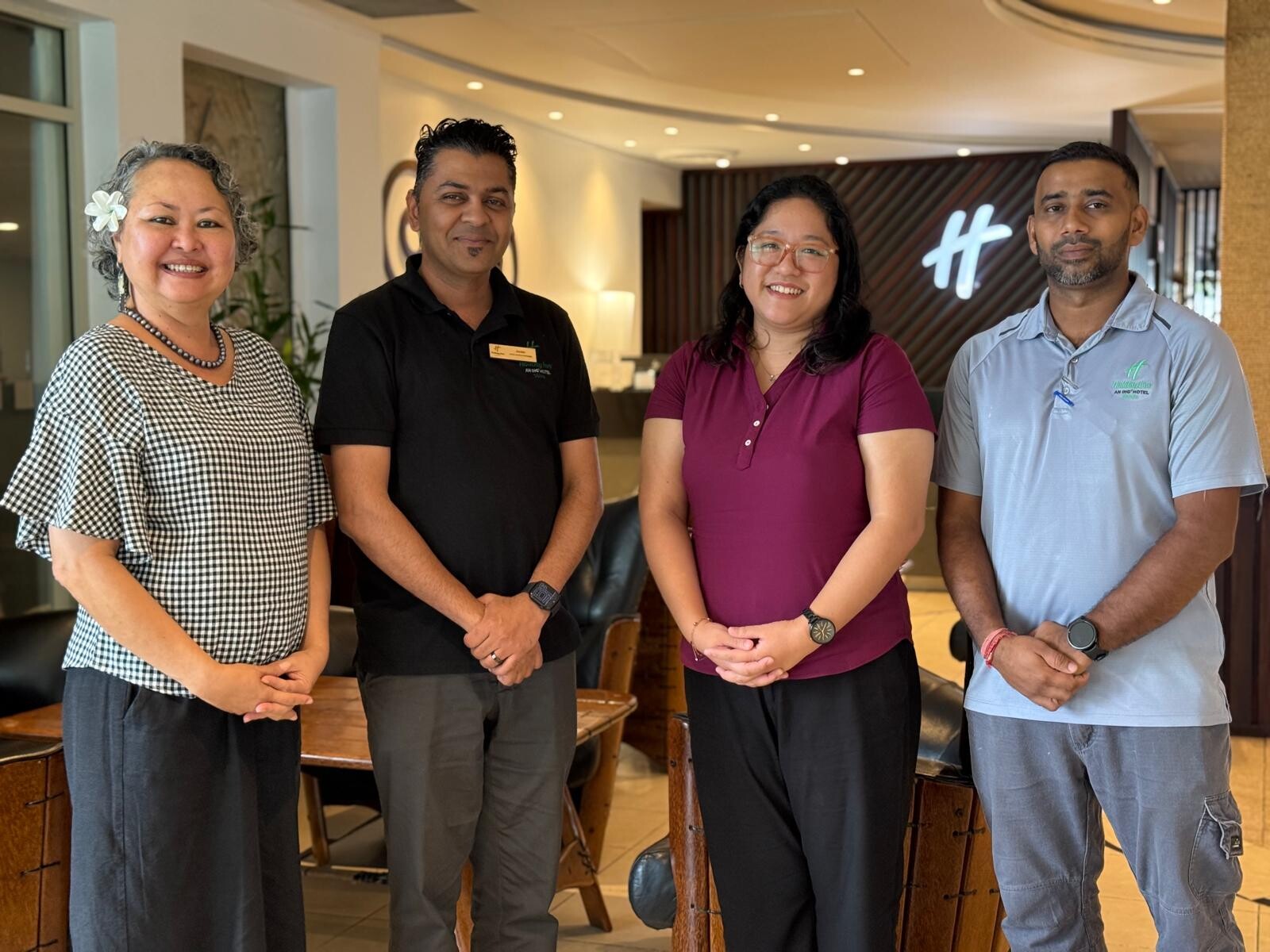 Group photo of four individuals standing side by side at a partnership event. From left to right: Sharyne Fong, CEO of Leadership Fiji; Jackie Verma, Hotel Services Manager at Holiday Inn Suva; Mira Chipongian, Program Coordinator at Leadership Fiji; and Krishneel Lingam, Engineering Supervisor at Holiday Inn Suva.